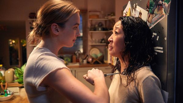 Still from Killing Eve featuring Villanelle holding a knife to Eve's throat. 