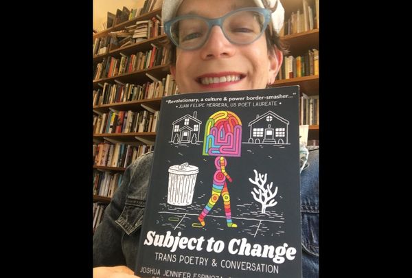 Stephanie Burt holding  Subject to Change, a book of trans poetry. 
