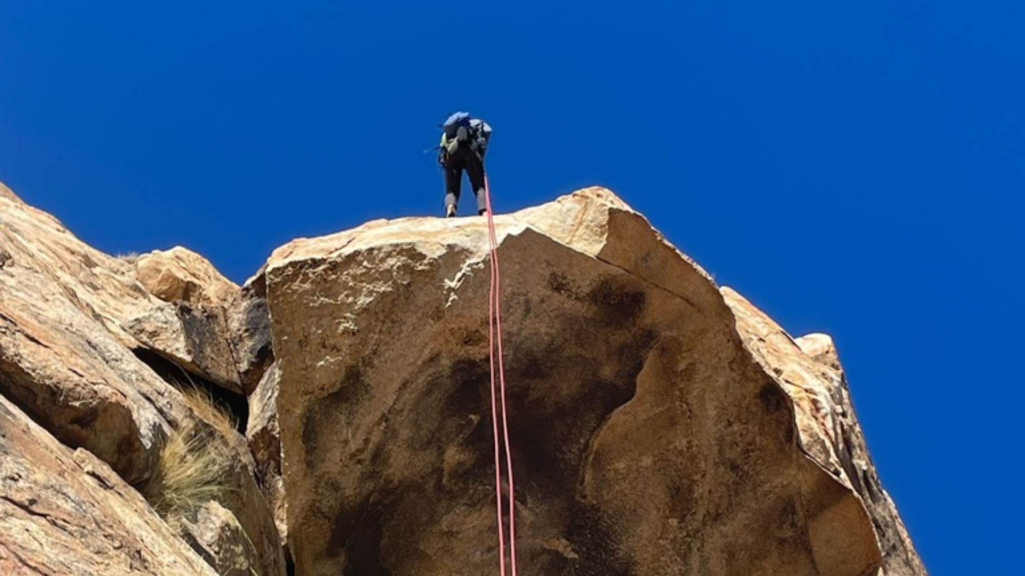 climber rappelling from the summit