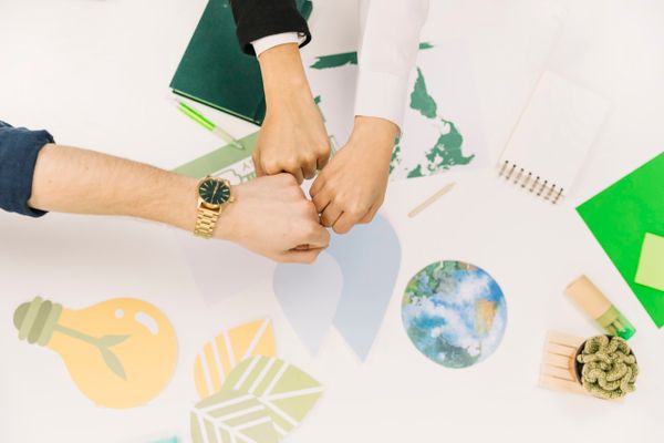 group-businesspeople-fist-bumping-desk