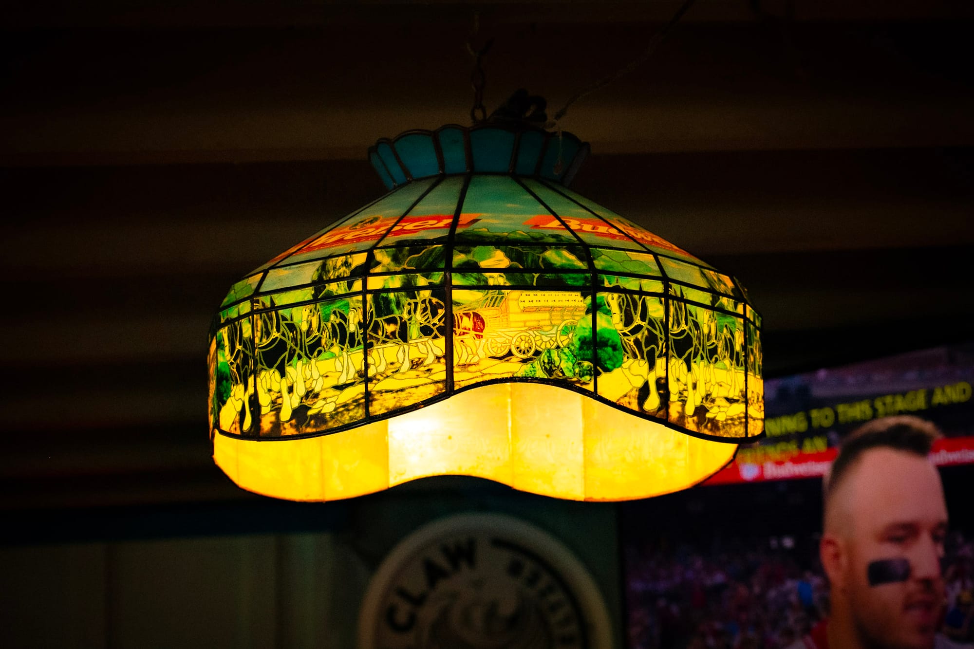 a warm, glowing image of an illuminated vintage Budweiser Clydesdale stained glass lamp