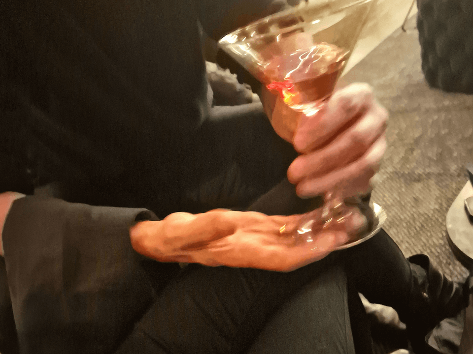 Half-empty glass on a bar counter at a Berlin club, low light, essay on drink spiking in Berlin clubs and how to stay safer
