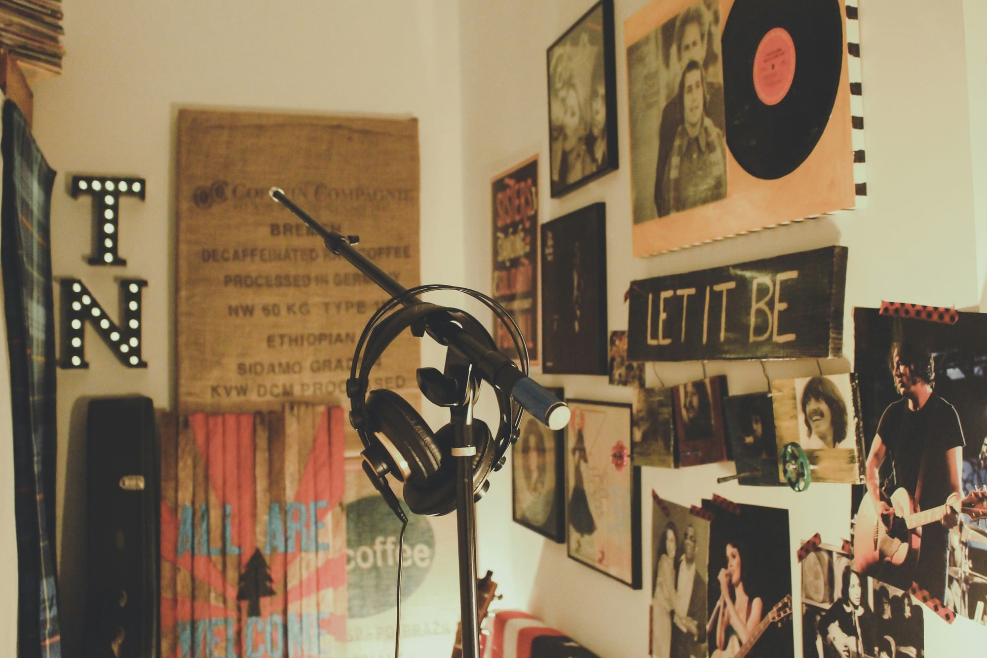 A picture of a home studio with a mic stand and headphones  a relaxing setting where music can be enjoyed 