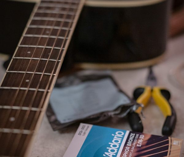 Guitar being prepared to be setup with lighter strings to support easier playing 