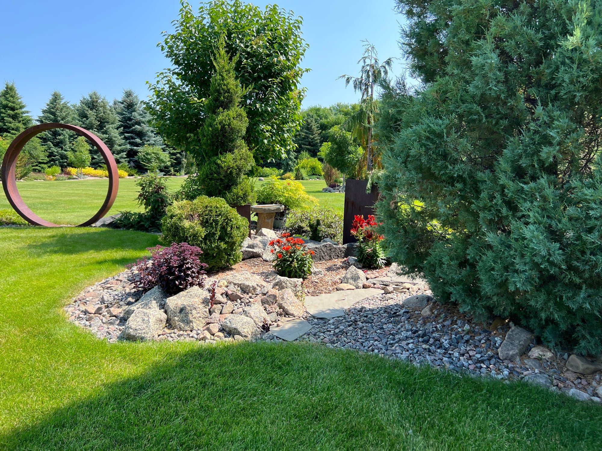 Landscape Bed With Plants, Pathway, And Rock