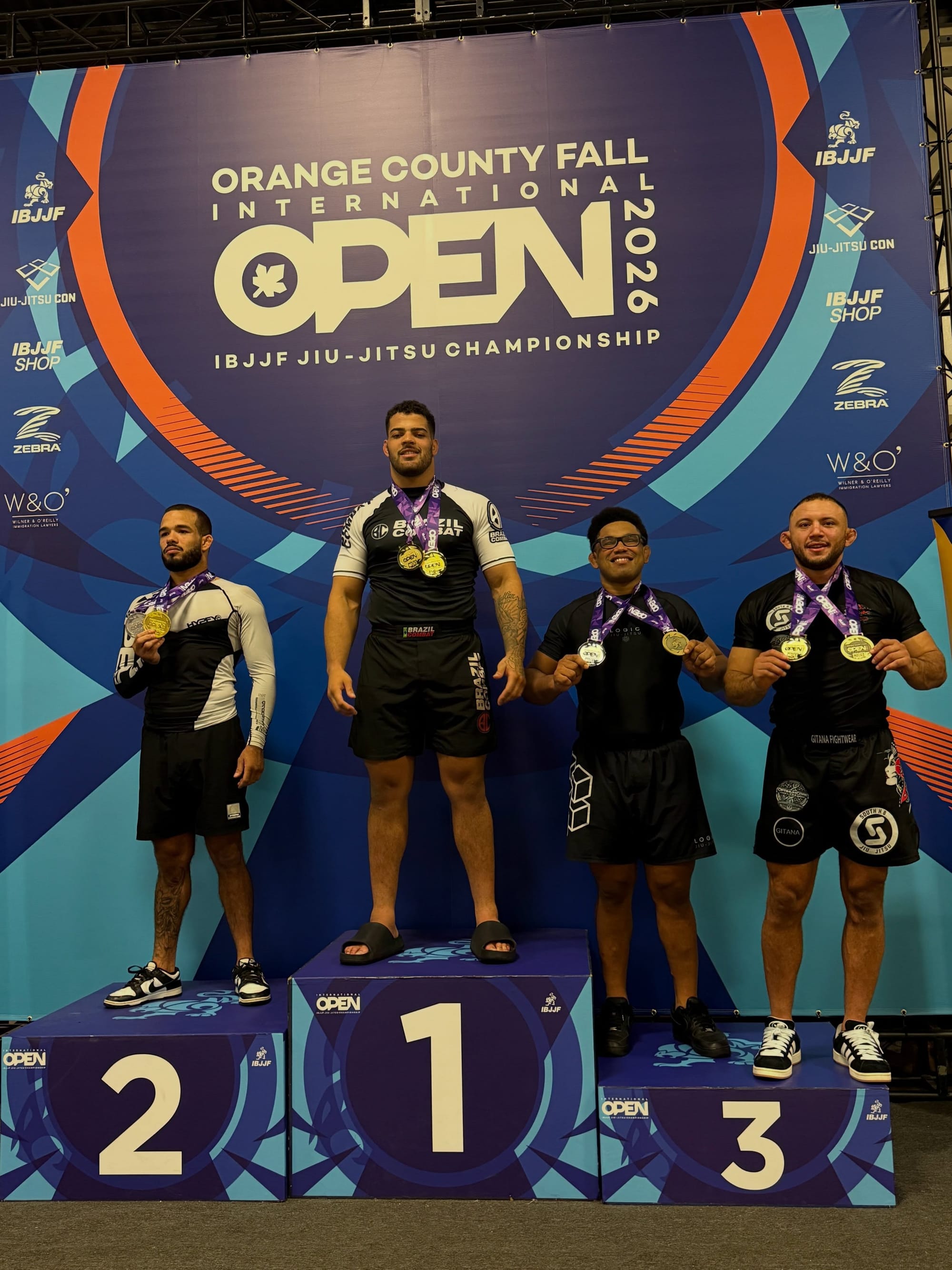 Adrian Roberto standing on the first-place podium with fellow no-gi competitors at the Orange County Fall Open.