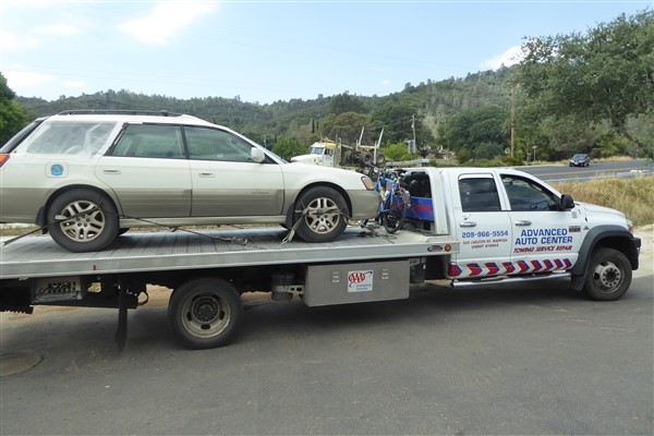  This photo of the tow truck that brought Francois to Merced was taken by Francois Hennebert and is featured on his website: [http://velo.hennebert.fr/][0] . The bike is between the car on the flatbed and the truck cab. 