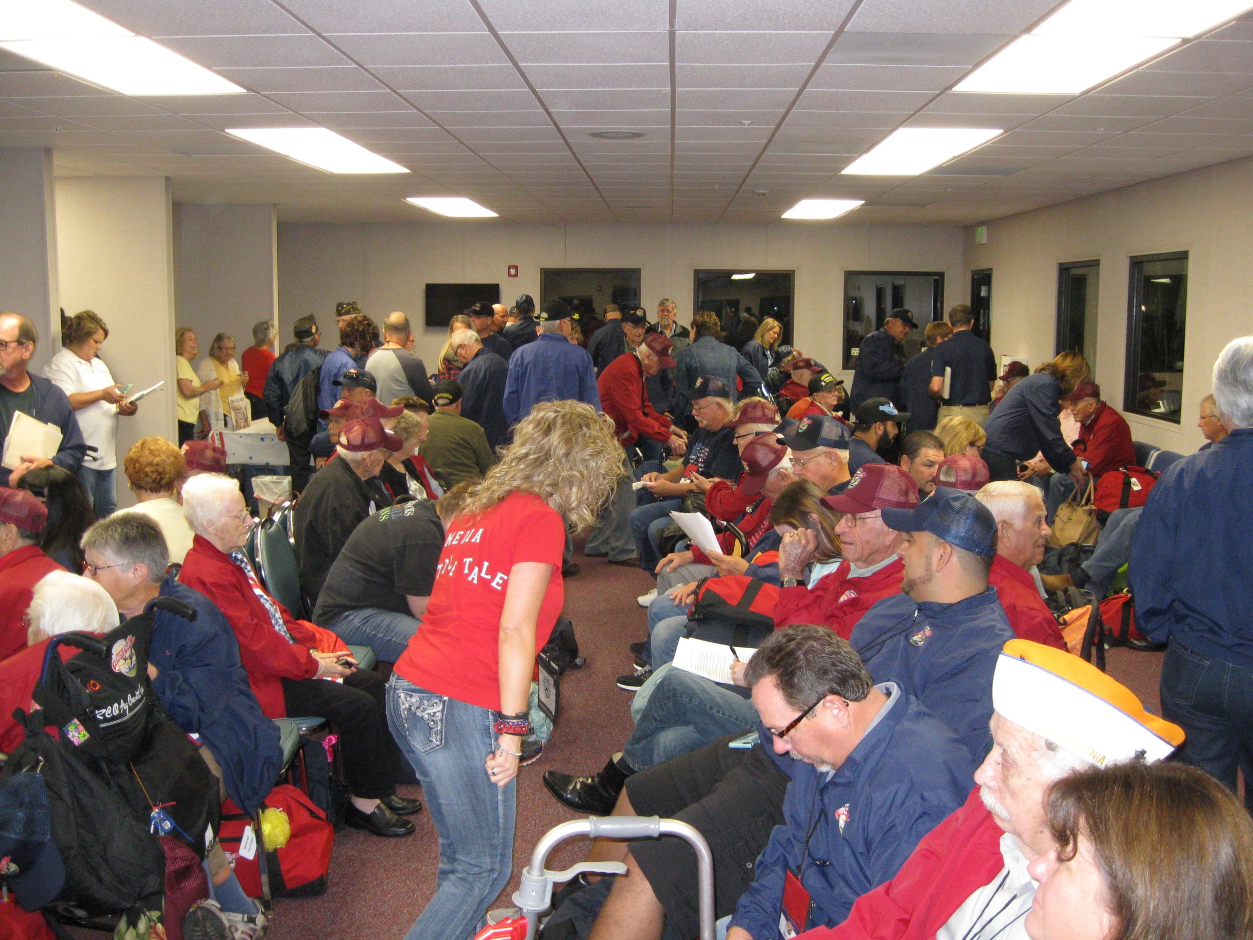  Veterans, their Honor Flight guardians, and other volunteers assemble at Castle Airport in Atwater, Merced County.  Photo by Steve Newvine 