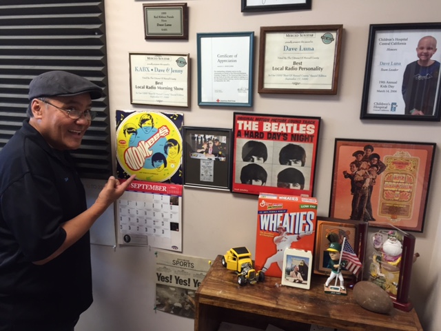  Dave Luna keeps rock and roll photos and vintage album covers on the studio wall at the Radio Merced offices on Main Street in Merced.  Photo by Steve Newvine 
