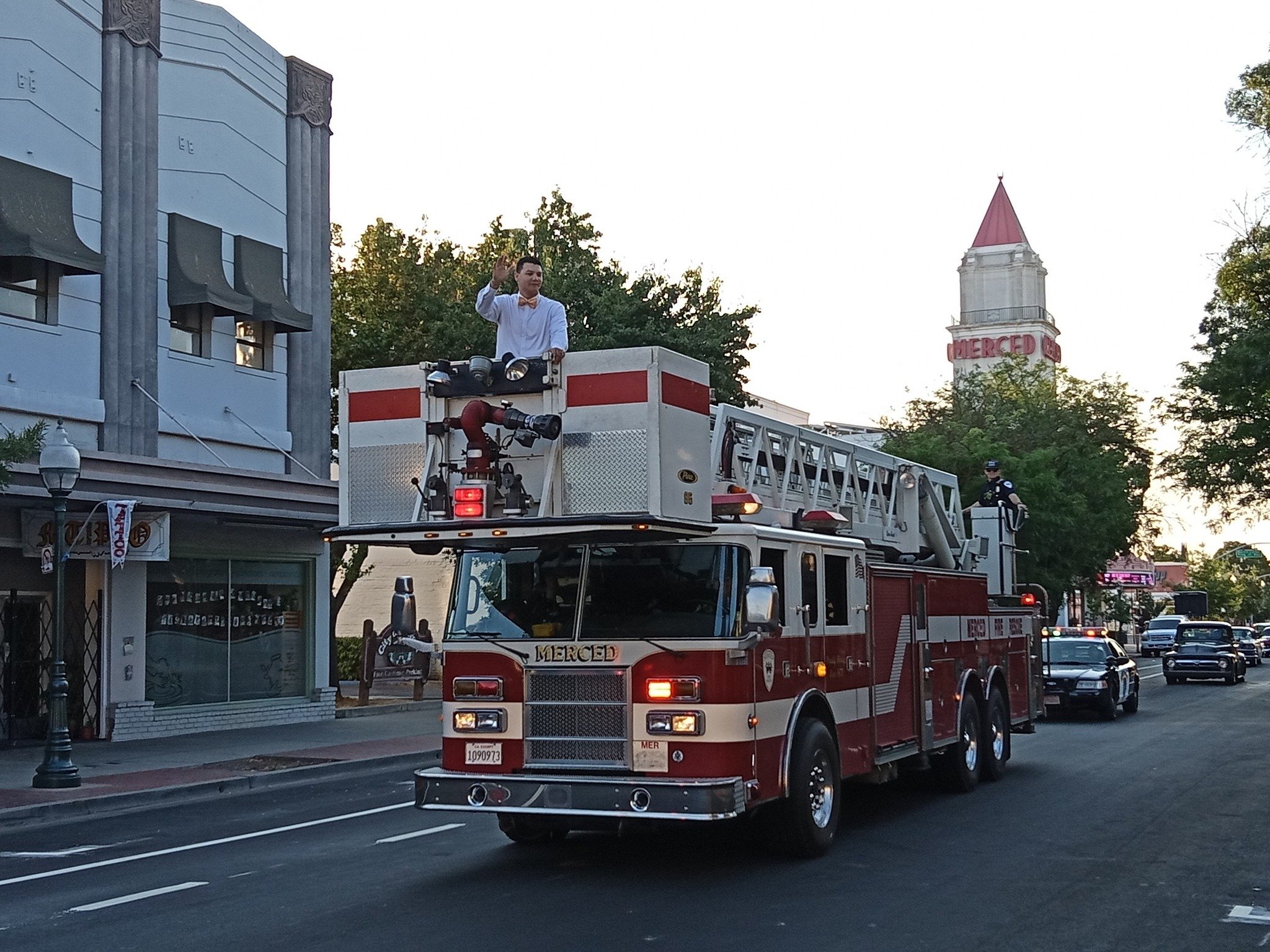  City Council Member Darin Dupont rides on top of the City Fire Department’s ladder truck at the Main Street Reopening Cruise. Photo: Steve Newvine 