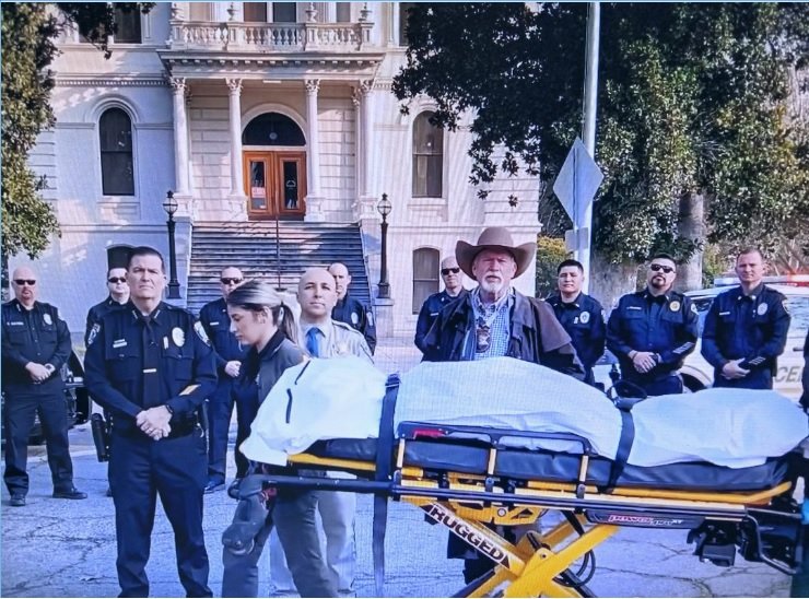  Merced Police Chief Steve Stanfield, CHP captain Tony Domiguez , and County Sheriff Verne Warnke stand behind a gurney with their reminder of how dangerous a traffic collision can be if passengers are not wearing seat belts.  Photo:  CHP 