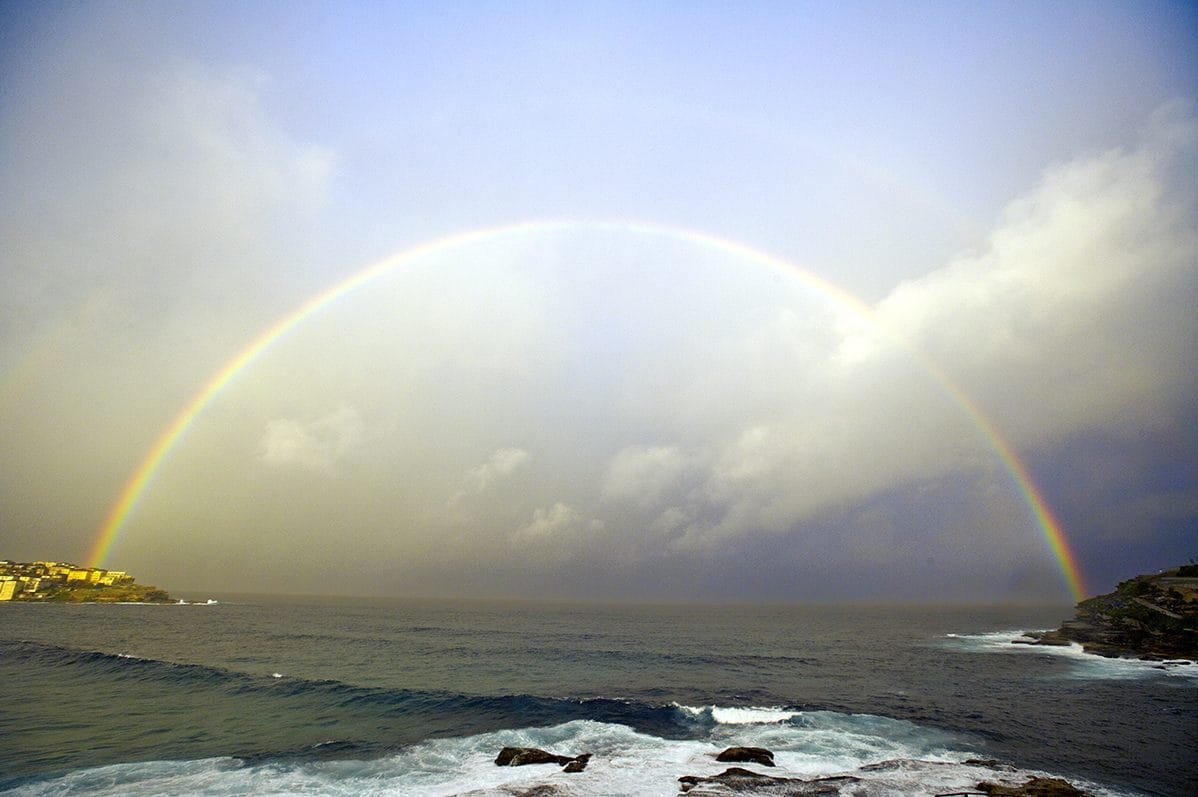 A rainbow landing on the sea off Bondi Beach