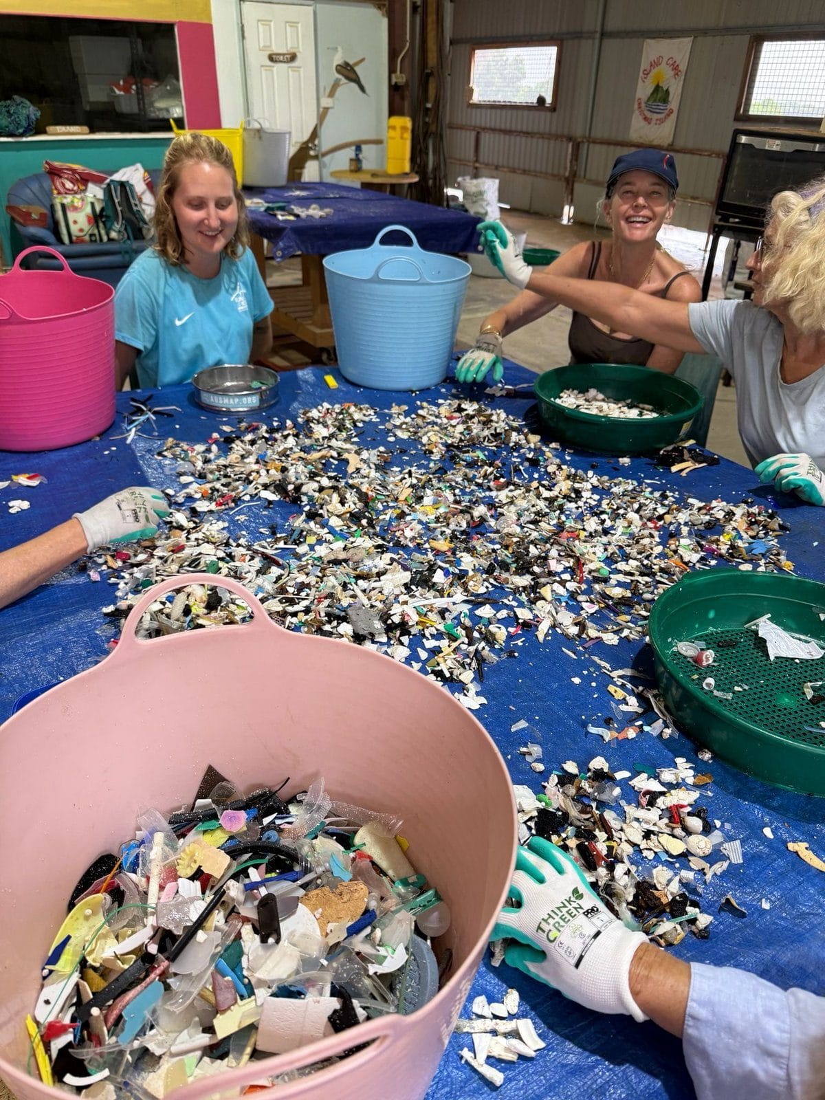 Volunteers counting and categorising marine debris at the sorting table on Christmas Island