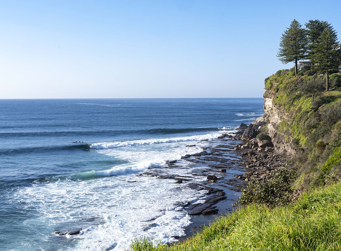 The Little Avalon point and rock shelf with surfers waiting on the shoulder