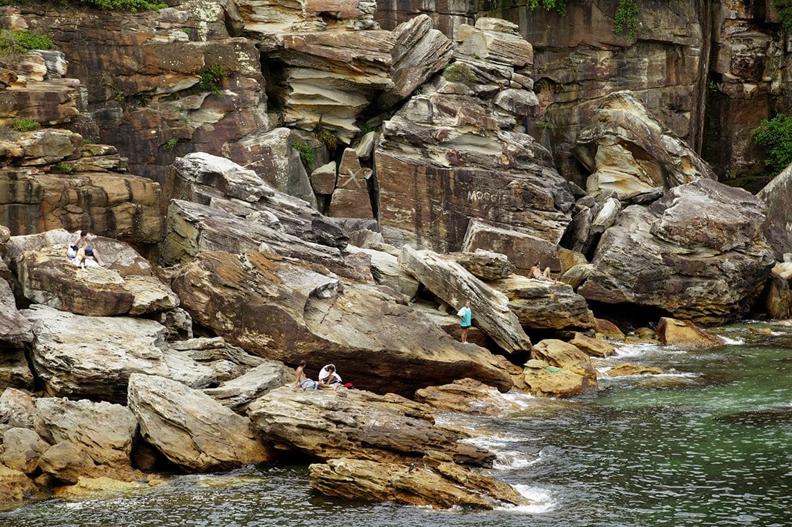 Sandstone boulders and clear green water at Gordons Bay, Sydney