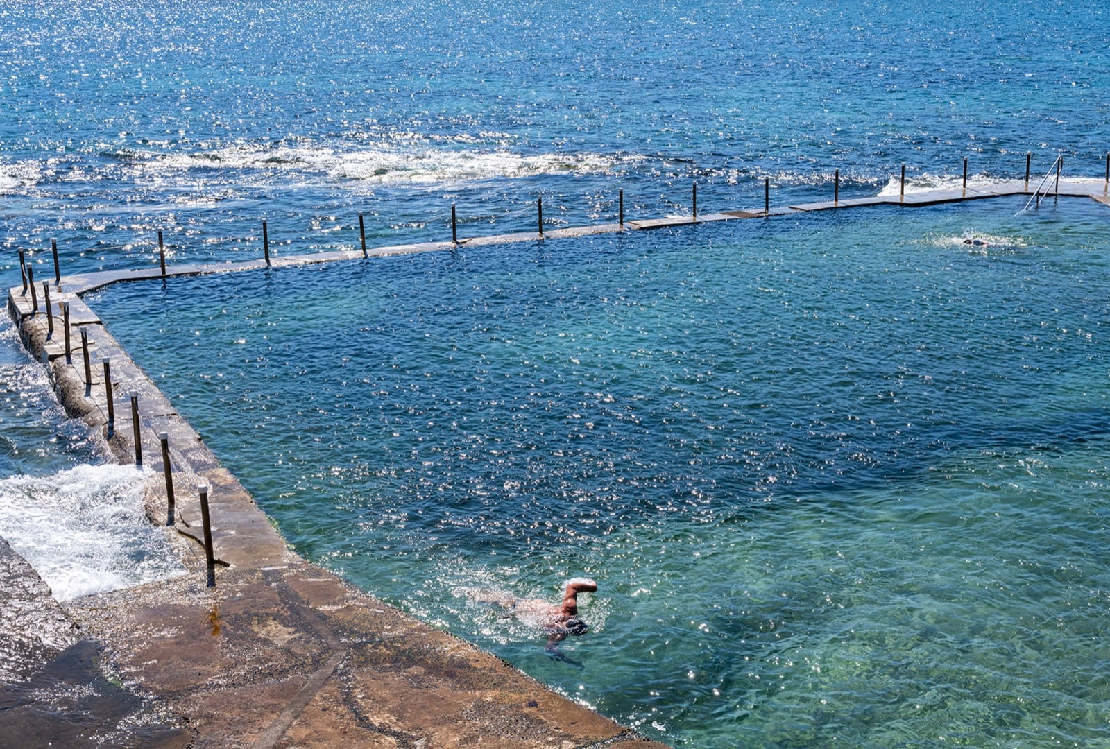 Malabar Ocean Pool from above, a swimmer in the shallows