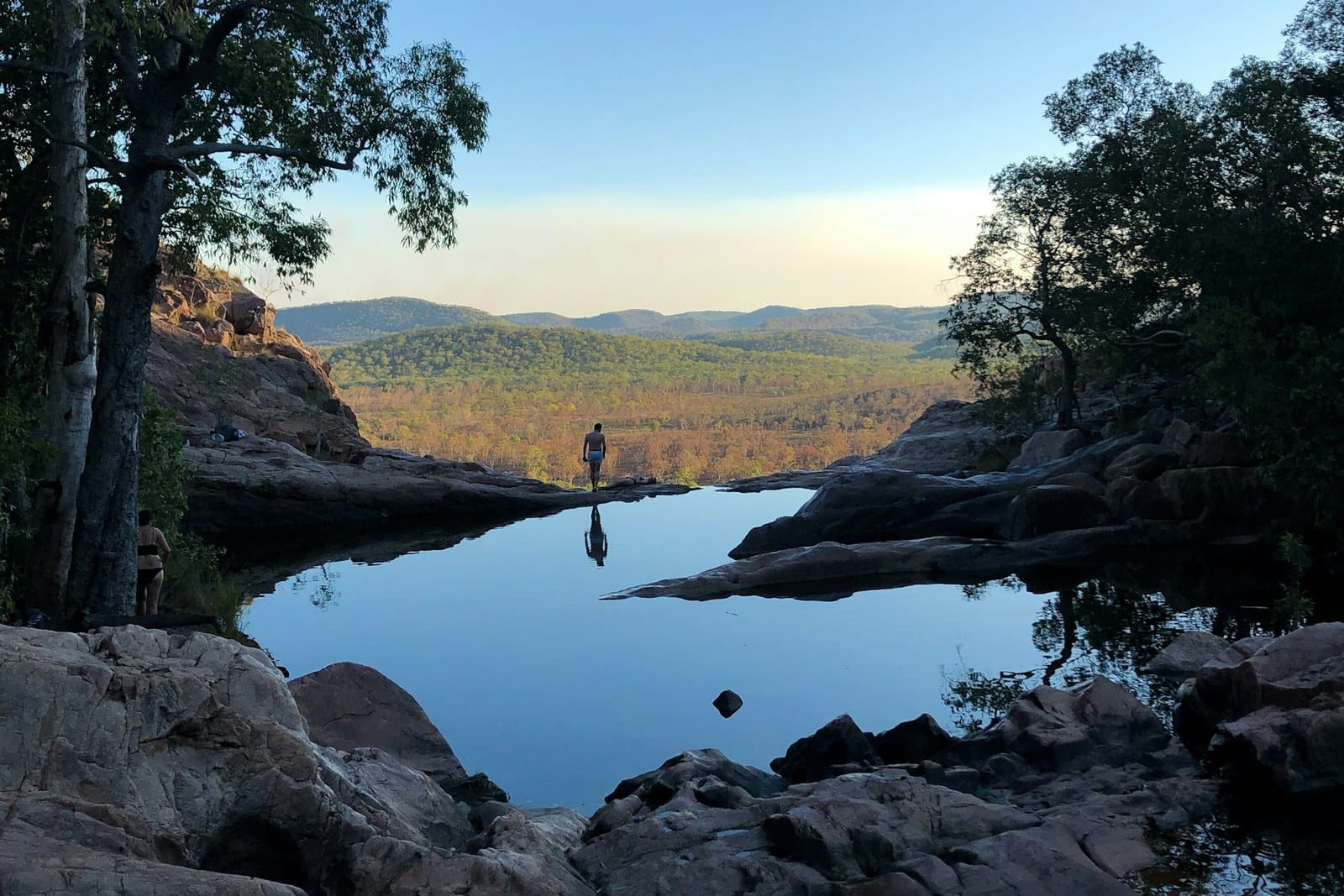 The plunge pool below Gunlom Falls with cliffs reflected in still water