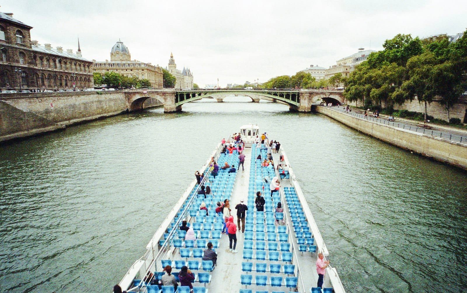 A boat gliding along the Seine in Paris in soft evening light