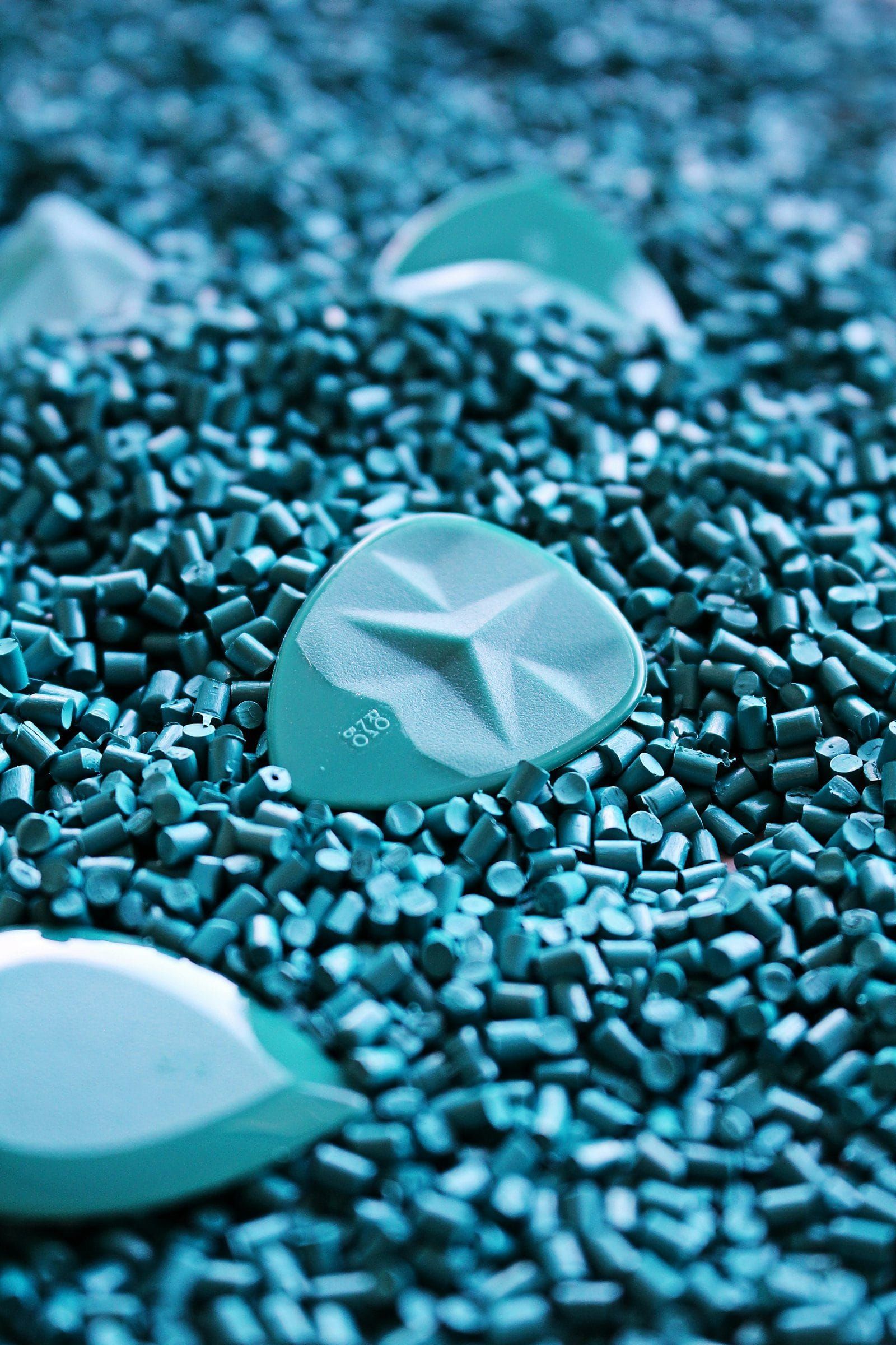 Small teal pellets, the shape of a natural plastic alternative, a stand in for ULUU's seaweed made material