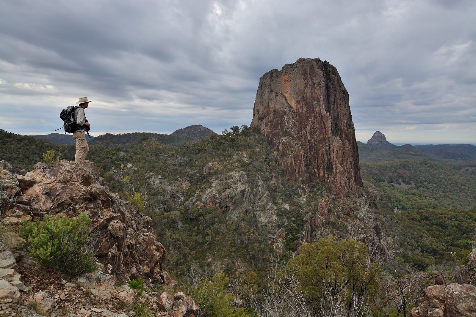 A walker on the Grand High Tops looking across to Belougery Spire and the Breadknife, Warrumbungle National Park