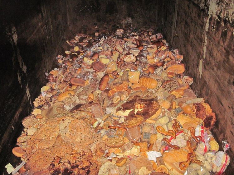 A bin of surplus loaves and pastries from an industrial bakery