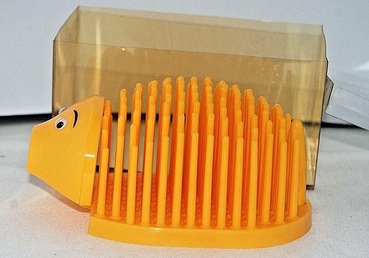 A yellow pencil sharpener that is in the shape of a hedgehog