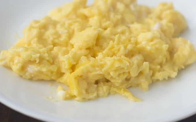 Scrambled Eggs on a white plate.