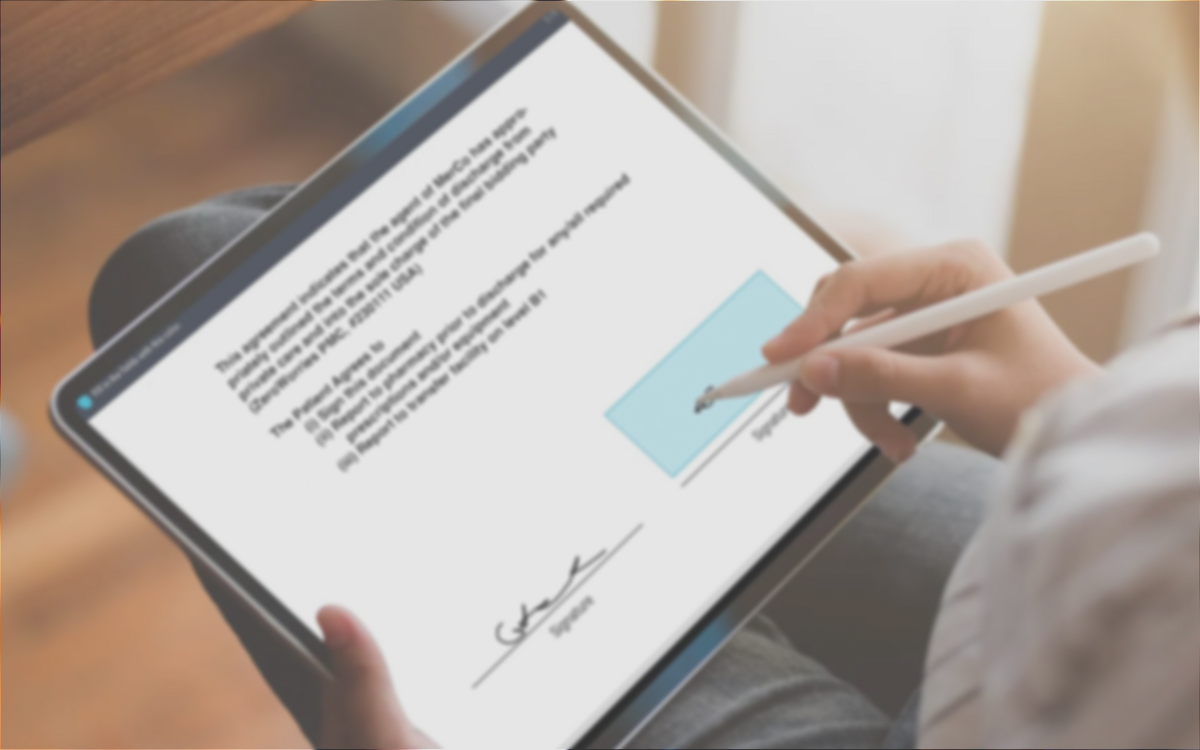 A person with a hand signing a signature field on a tablet