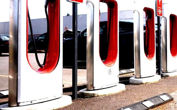 A row of Tesla superchrager stations.