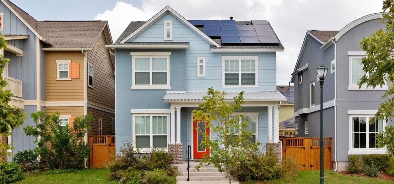 Homes in Mueller Neighborhood of East Austin. Several Homes Pictured with Small but Nicely Manicured Lawns and New but Historic Architecture Style Homes. 