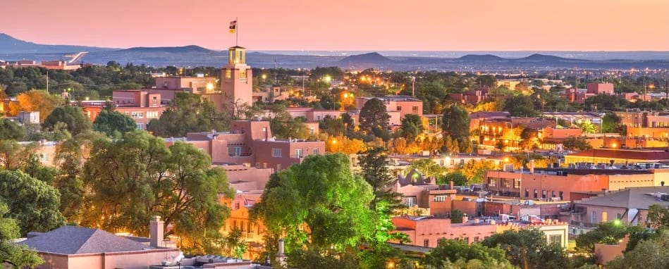 Aerial View of Sante Fe, New Mexico at Sunset. Major commercial and downtown district pictured with desert and hills in the background. 