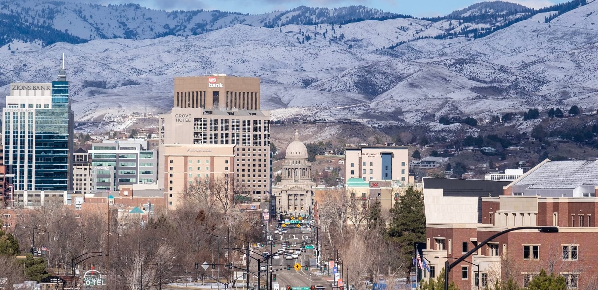 Stunning Image of the Boise, Idaho Skyline. The Capitol Building is in the center of the image but starkly framed by the snow-covered Boise Mountains in the background. 