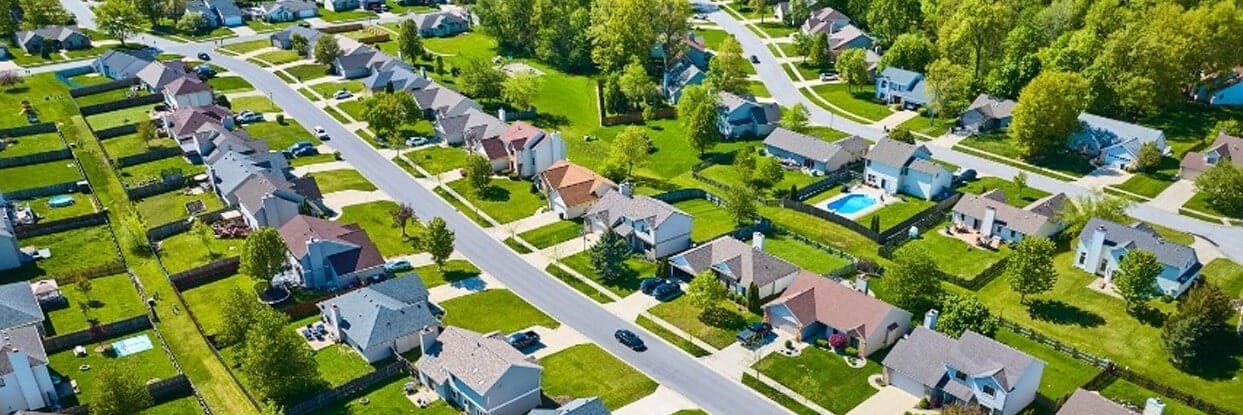 Aerial View of Leander, Texas. New Suburban Development with Nice Homes, Tree-lined Streets and Appearance of Trees in the Background. 