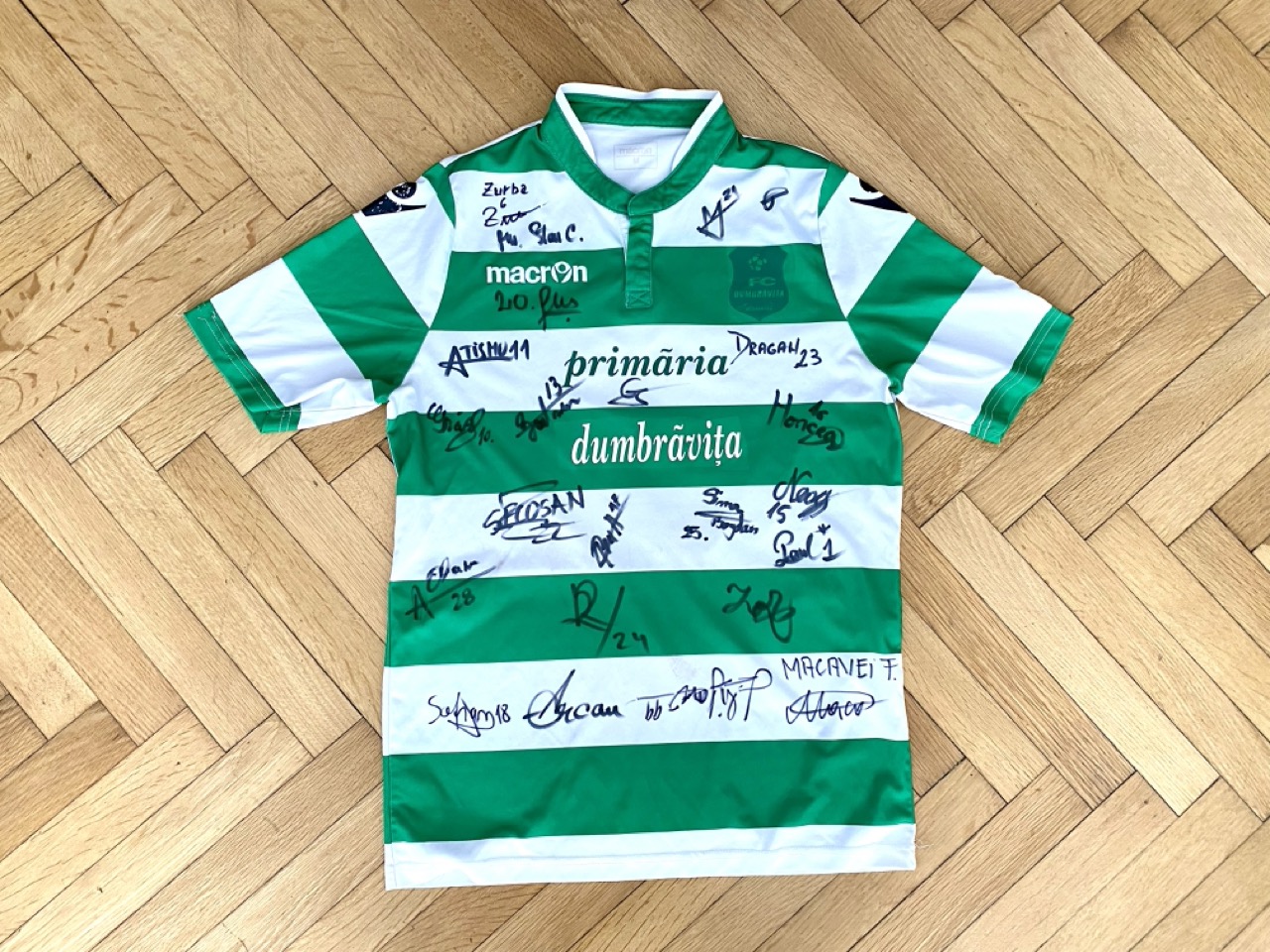 A photograph of a football shirt from CSC Dumbrăvița, with signatures from the players.