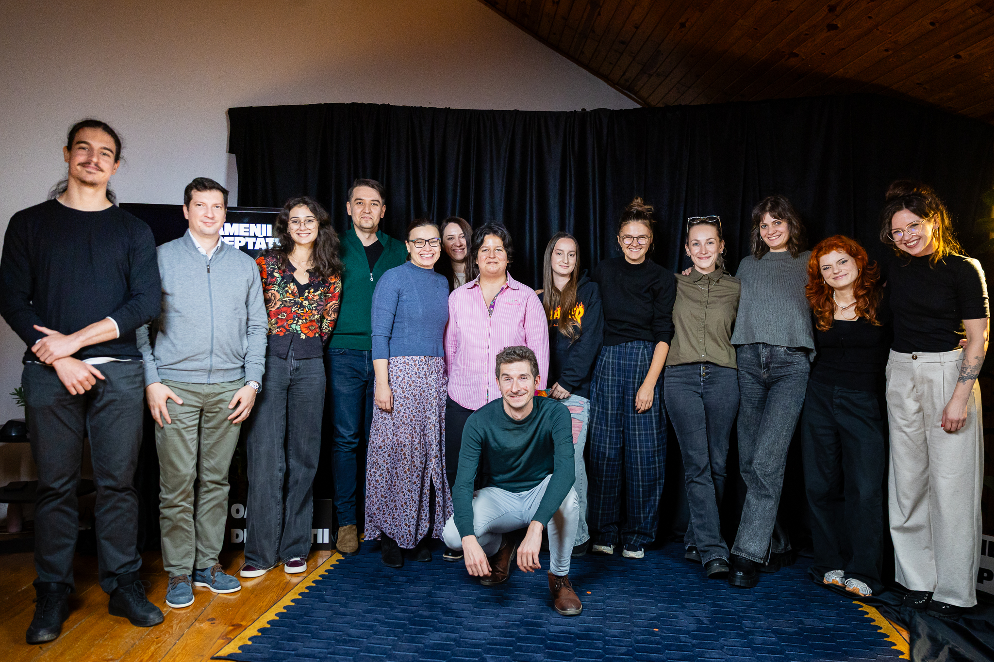 A group photo of about 15 people, after a live storytelling show.