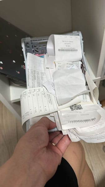 Stacks of physical receipts waiting to be scanned and recorded at Wong Lye Pte Ltd.