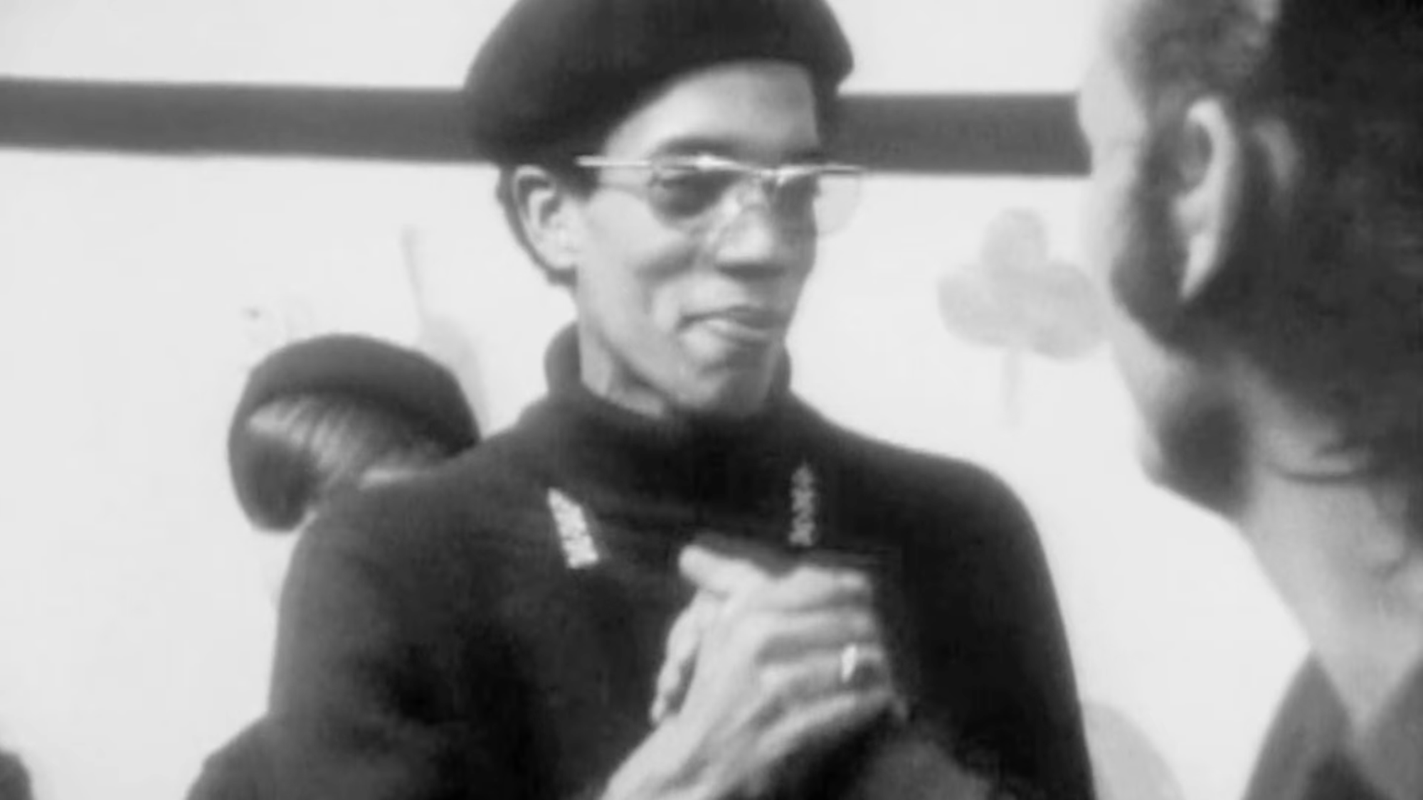 Still from the PBS documentary about the Black Panthers where Fred Hampton is shaking hands with a hillbilly.