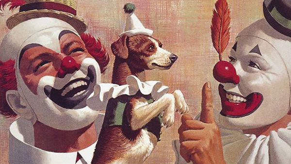 A picture of two clowns, with a small terrier dressed as a dog. One of the clowns is balancing a feather on their nose.