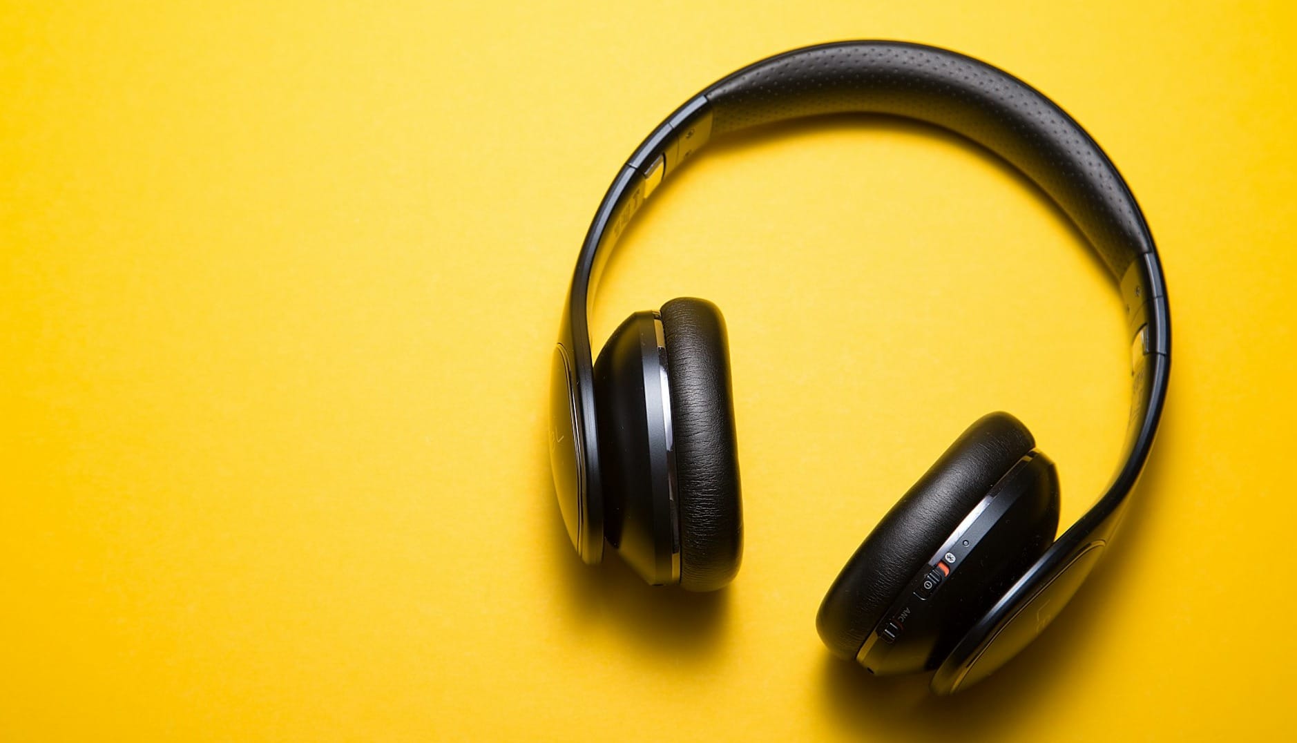 flatlay photography of wireless headphones