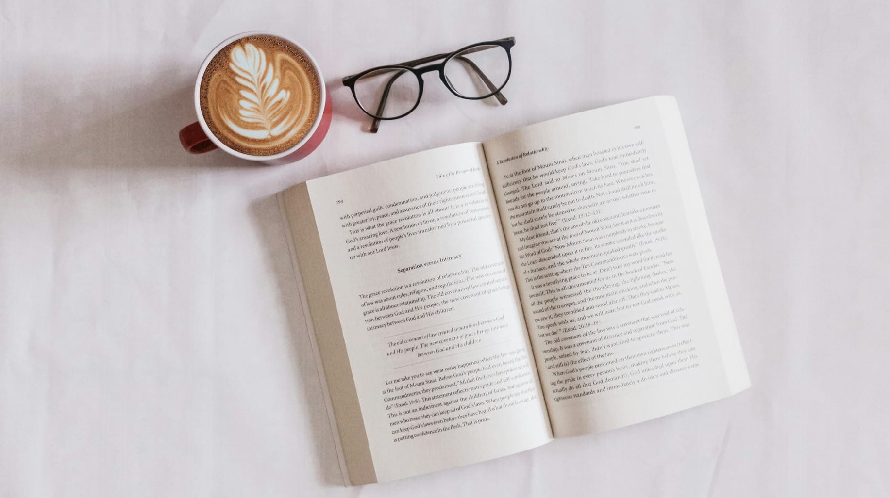 book near eyeglasses and cappuccino