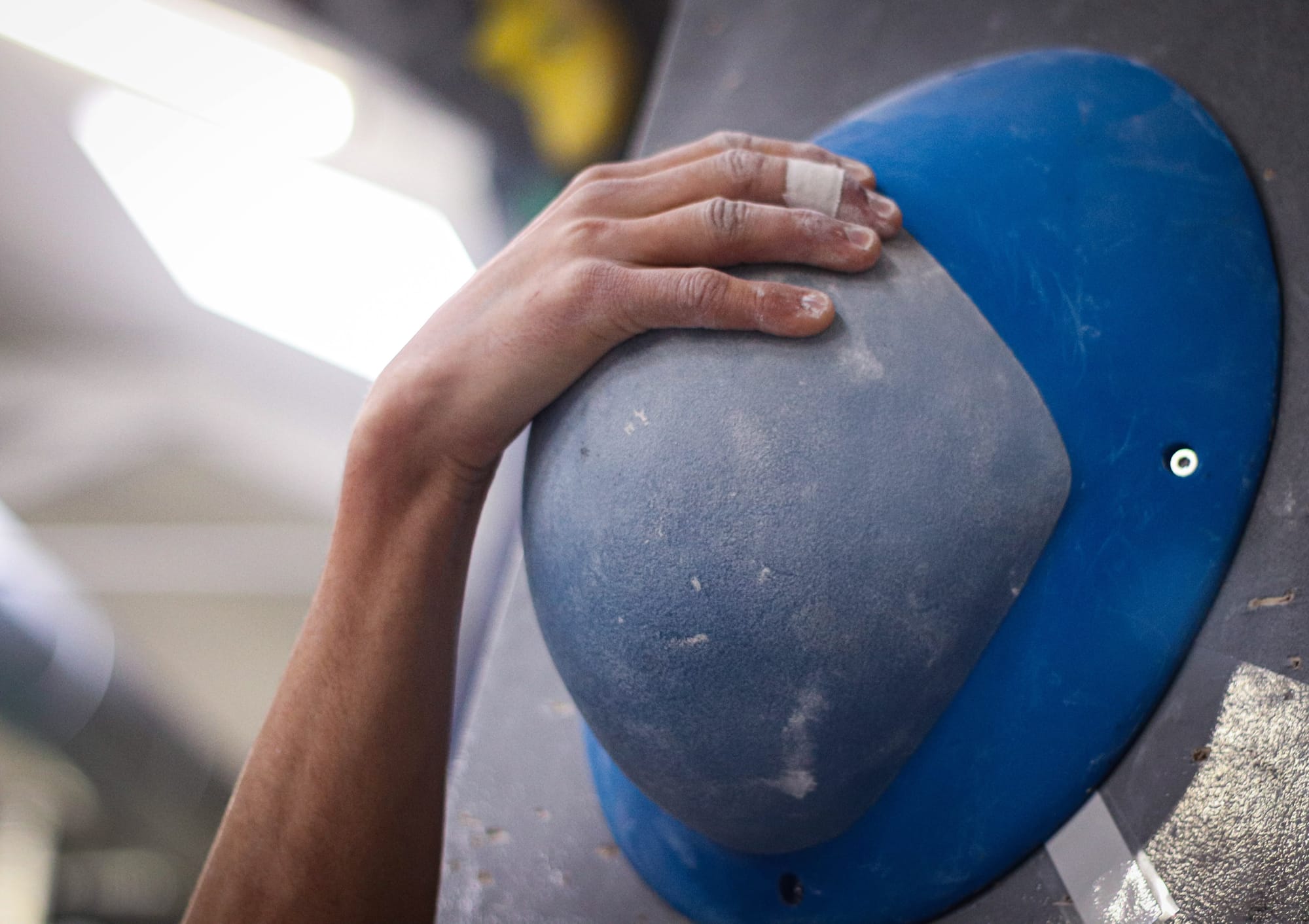 A climber gripping a hold on the wall