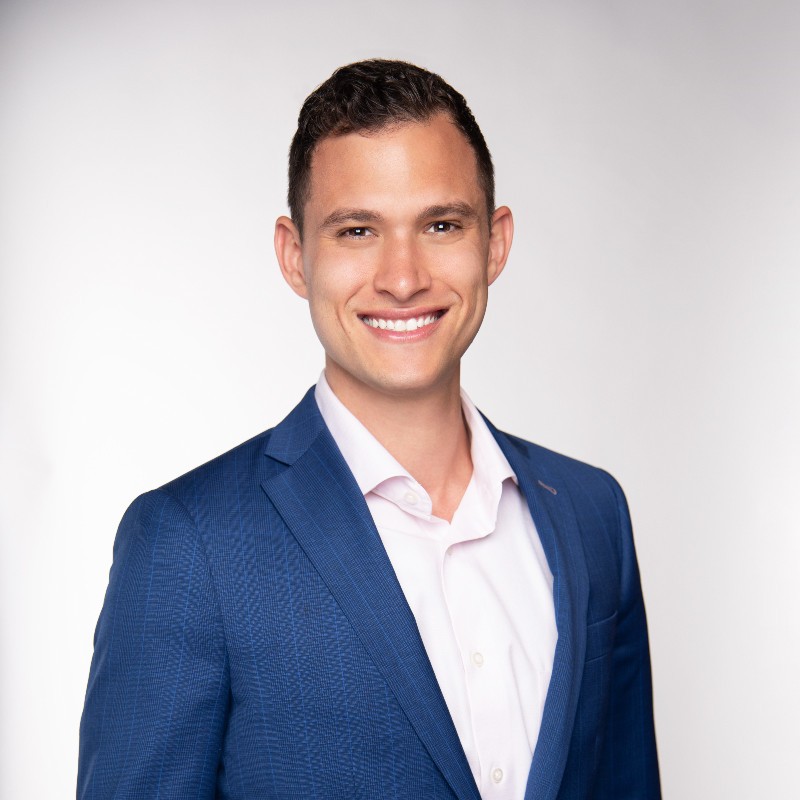 headshot of Daniel Beecham in a blue blazer