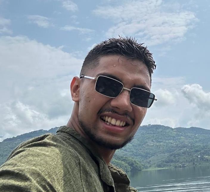 Headshot of Saugat Poudel of Station in a green shirt 