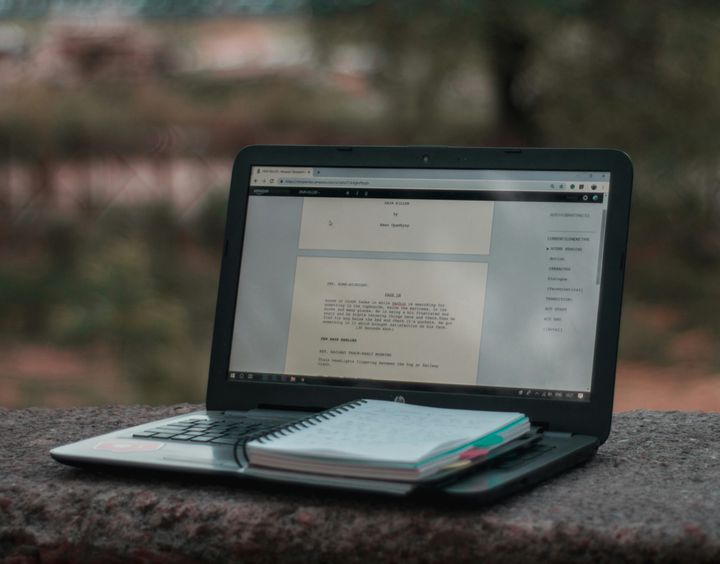 photo of a screenplay on a laptop computer