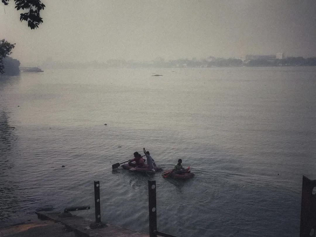 Fog over the Ganga with children out on the water