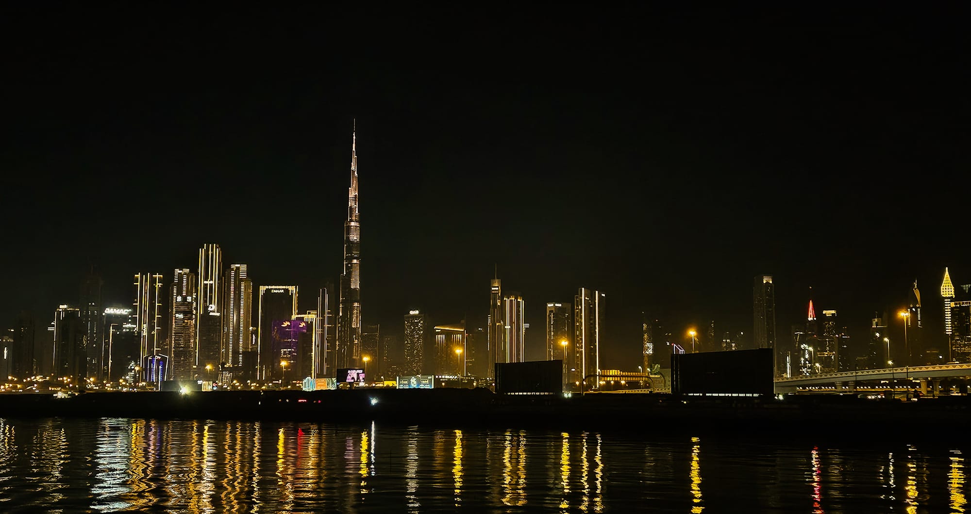 City lights after dark, mirrored on the water.