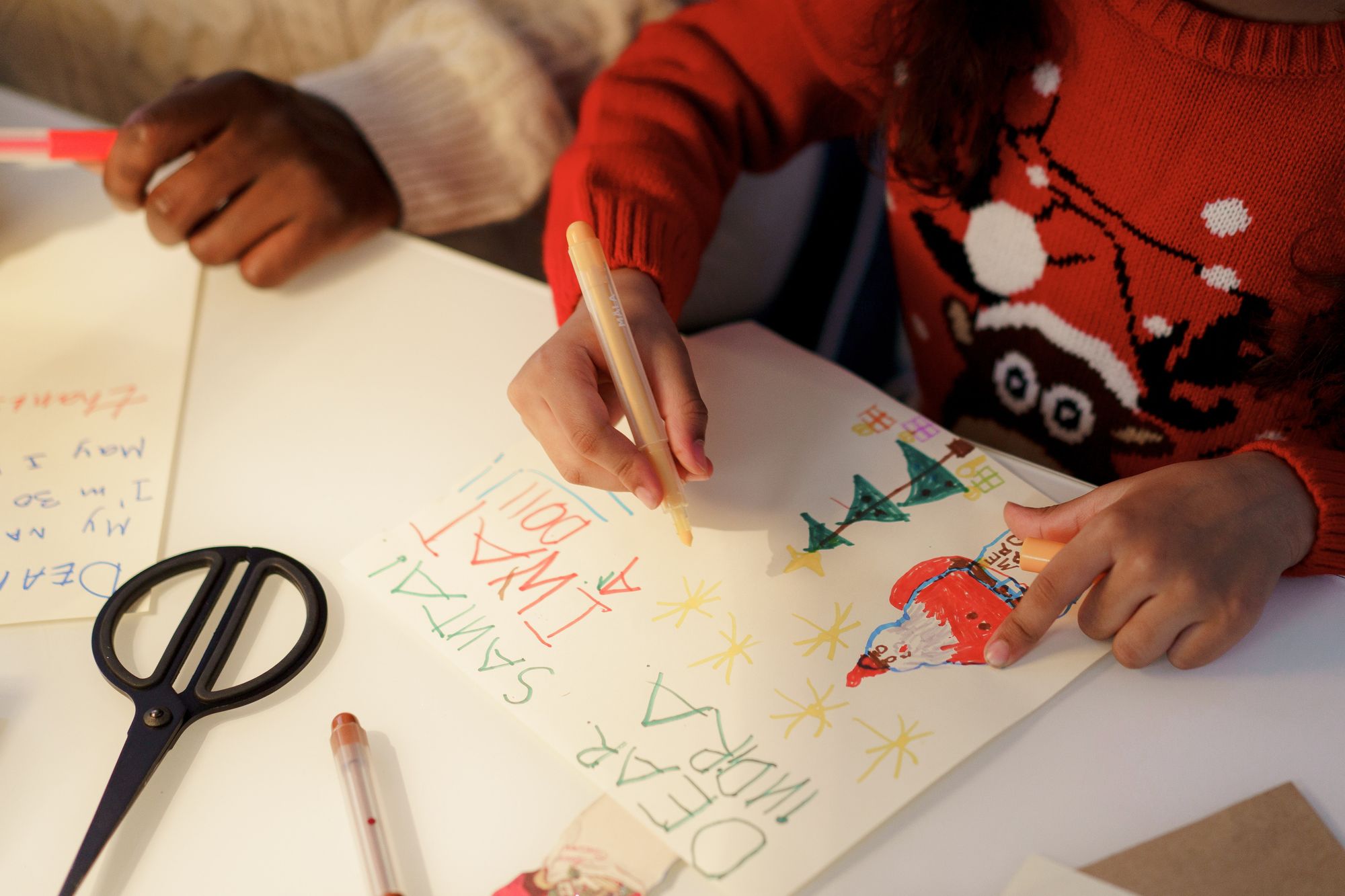 A girl writes her letter to Santa Claus