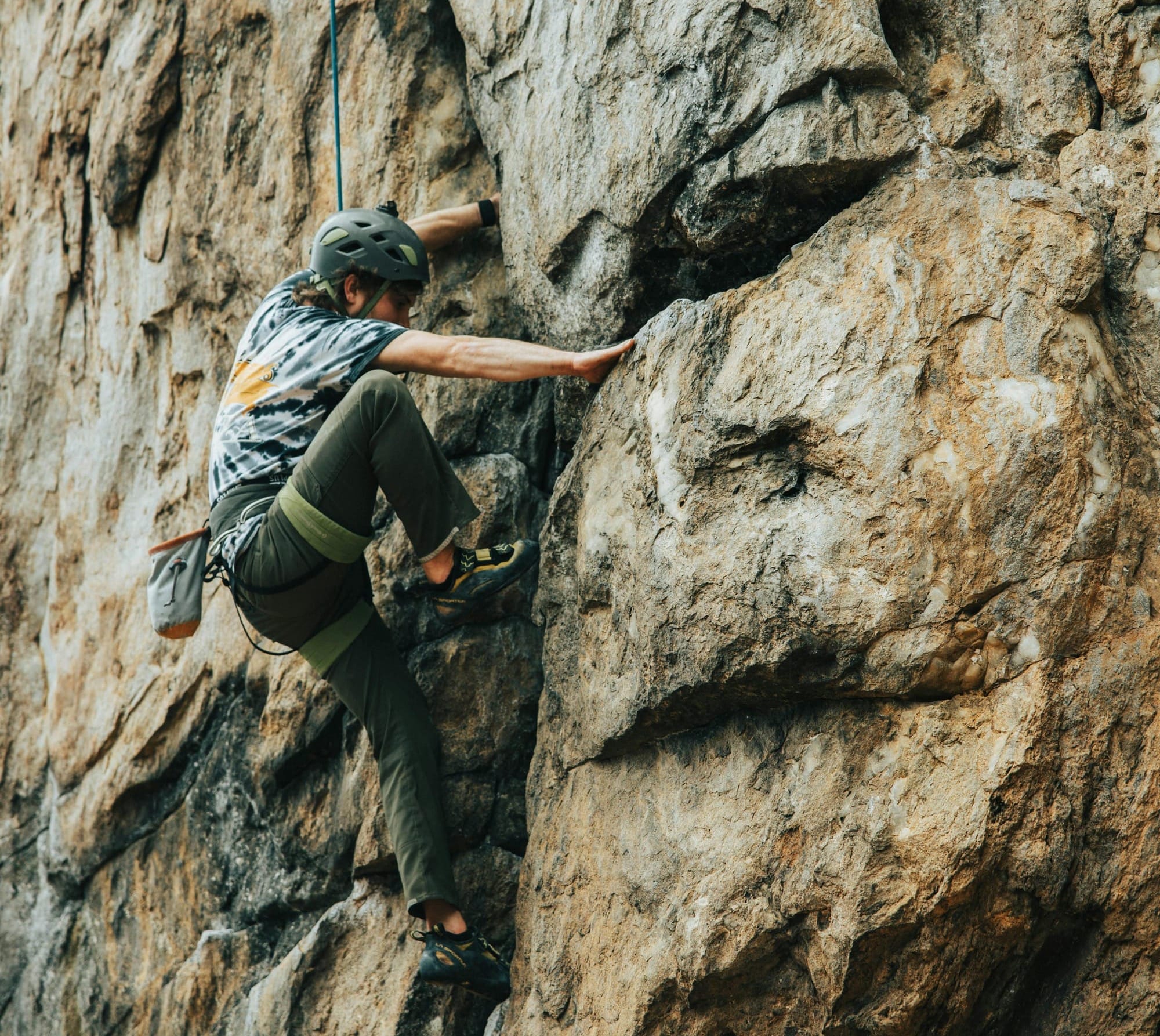 Tethered person rock climbing