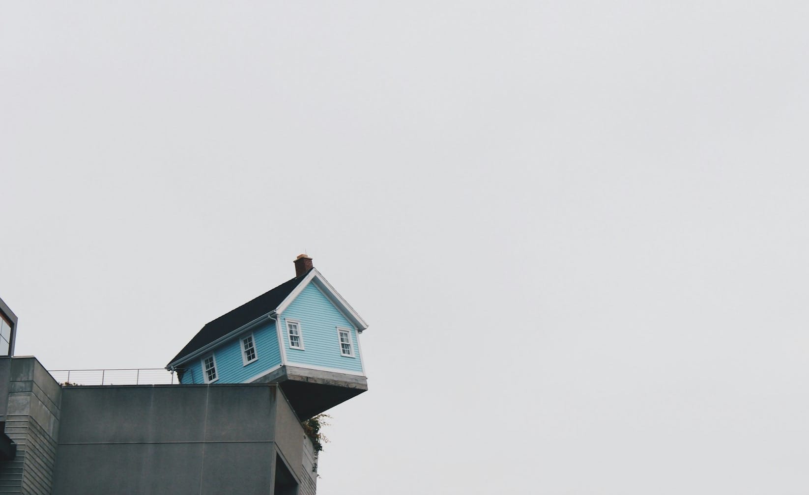 blue concrete storey house on top of building at daytime