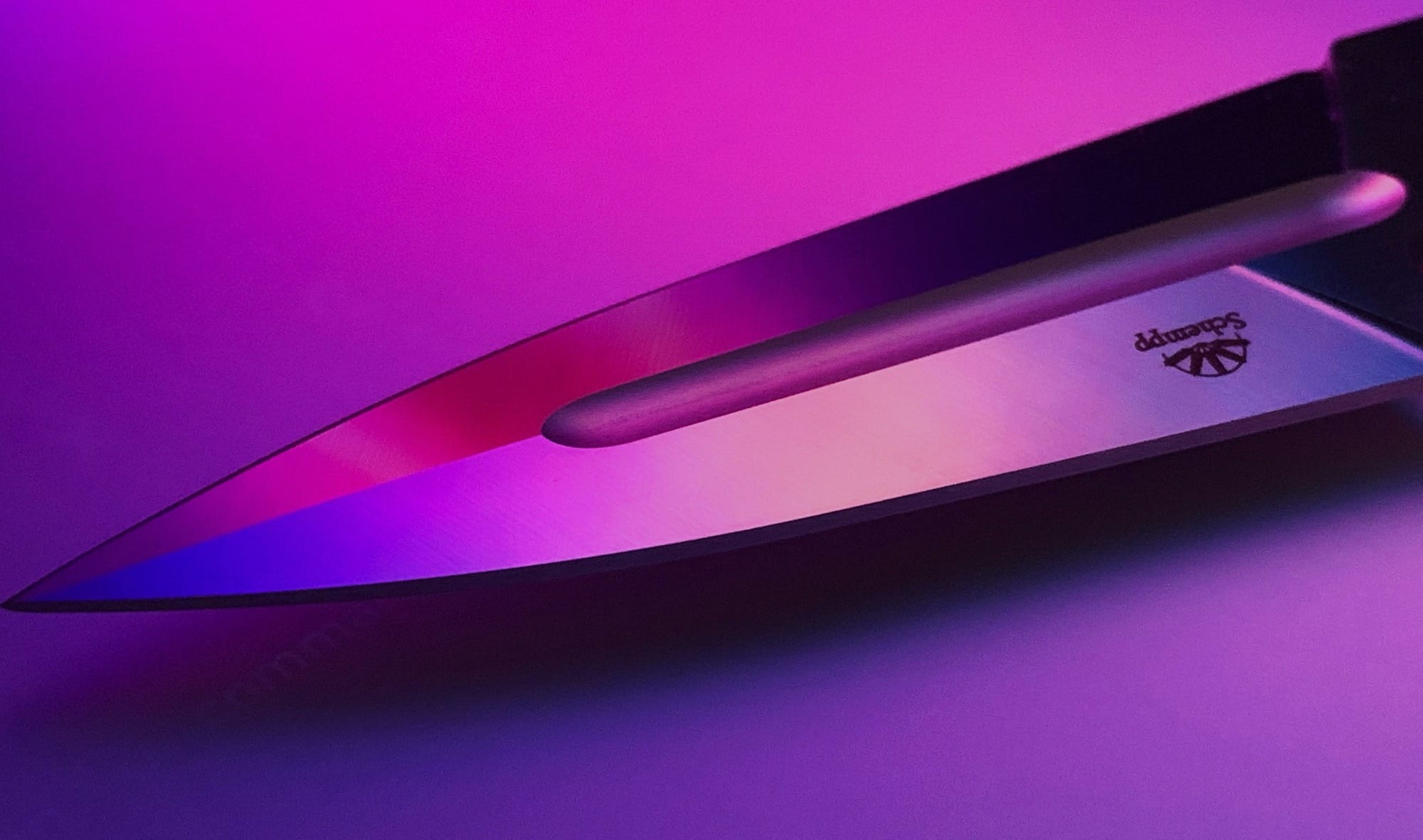 gray knife point on purple background